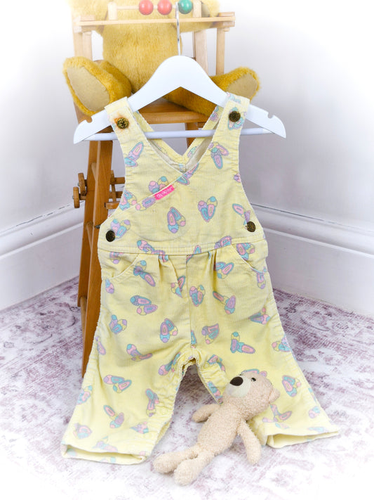 9-12 months. Lemon vintage corduroy Oshkosh dungarees with cute shoe print. Rust mark around button*