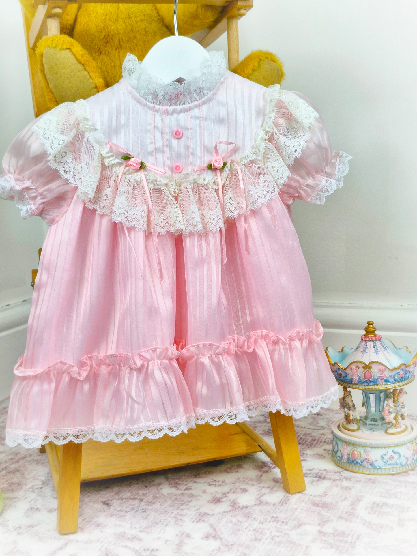 9-12 months. Pink and white frilly vintage dress by Haddad Brothers with lace and rosettes