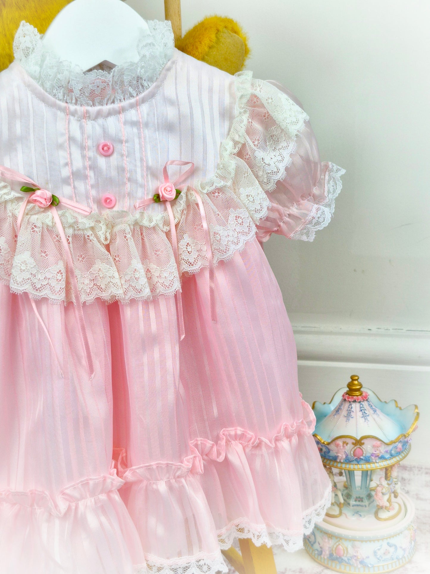 9-12 months. Pink and white frilly vintage dress by Haddad Brothers with lace and rosettes