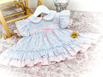 9-12 months. Pastel floral vintage dress from New York Kids, flutter sleeves, collar and pink satin ribbon