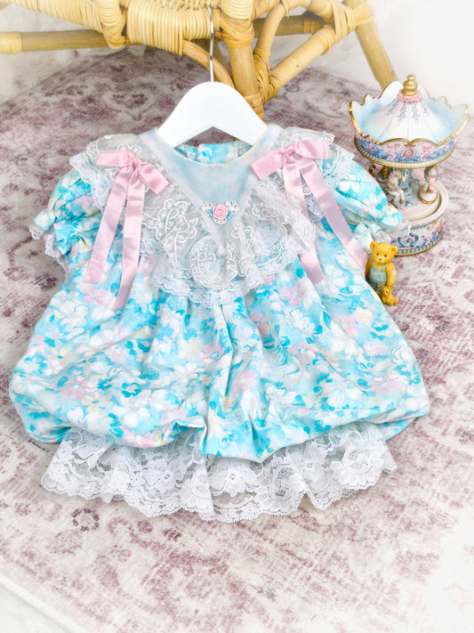 12-18 months. Vintage Rare Editions dress, blue with pink and white flowers and ribbons. Lace hem