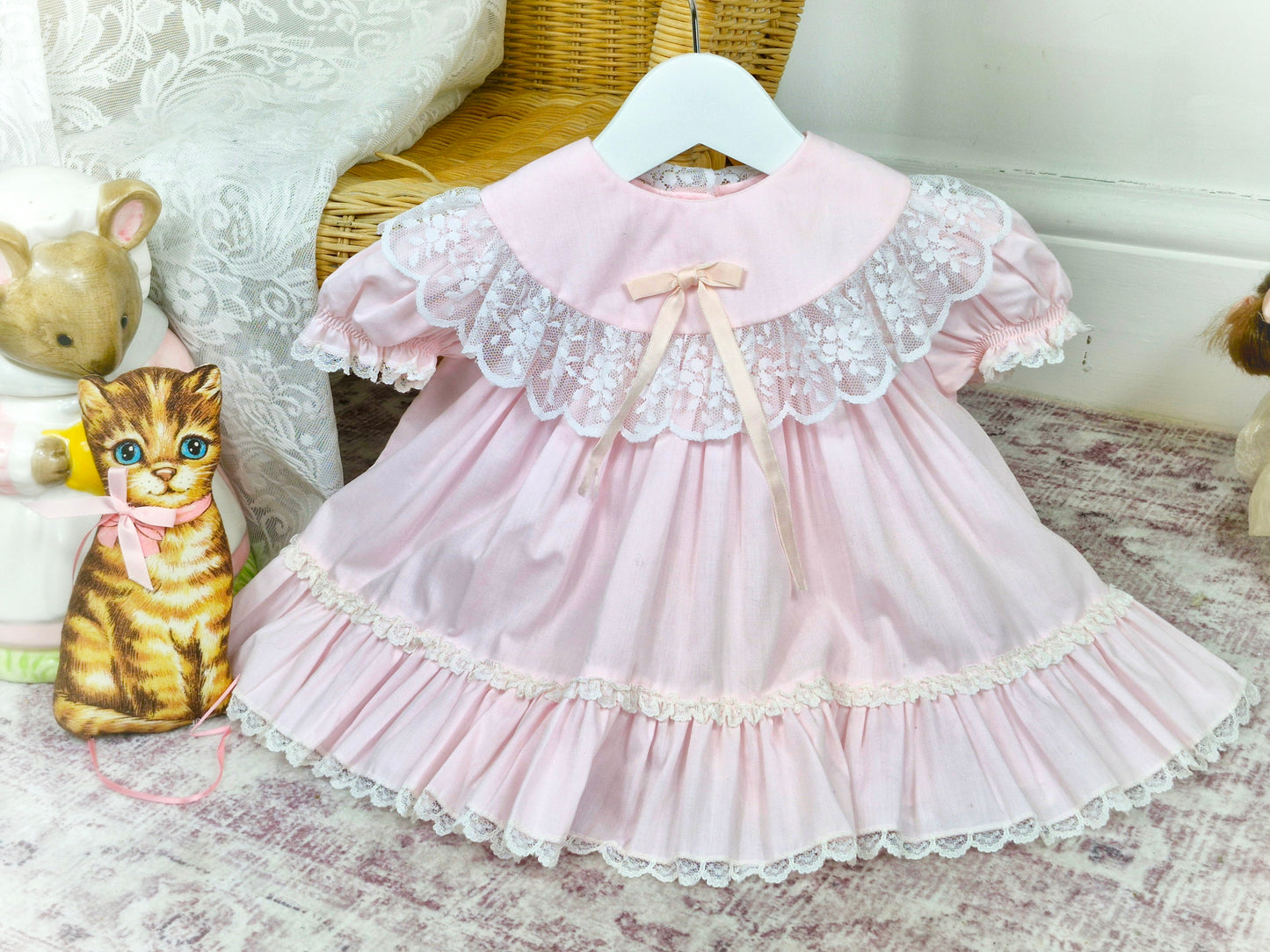 9 months. Pink vintage Bryan with white lace details, puff sleeves and satin bow
