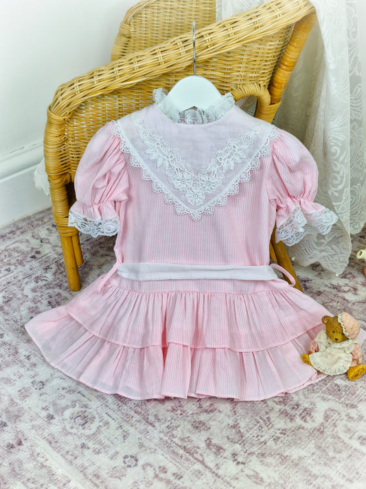 2 years. Pink and white striped vintage Bryan with drop waist, lace sleeves and white bib with lace trim