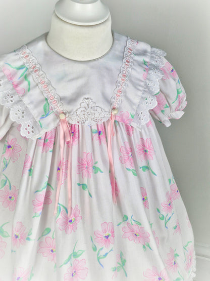 3 years. White vintage dress from Mini Togs with pink floral print, white bib with eyelet trim and pink satin ribbon