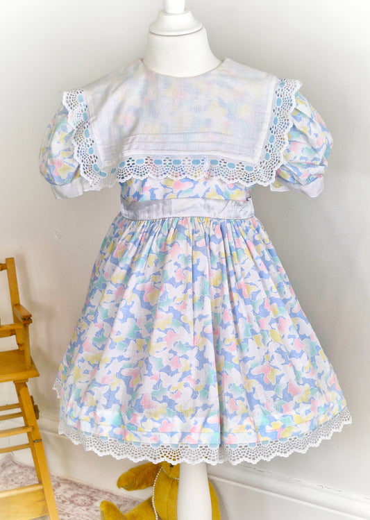 5 years. Vintage Cinderella butterfly dress with white bib and satin tie back