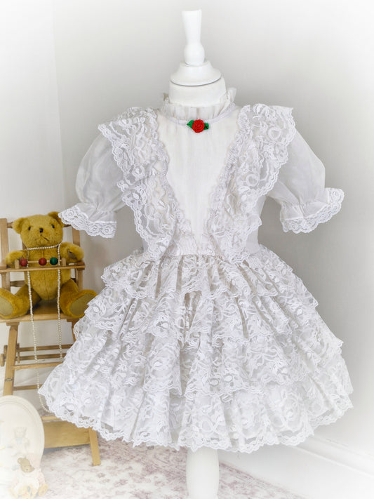 3-4 years. White vintage dress from Le Maj, with lace ruffles and small red rosette centre