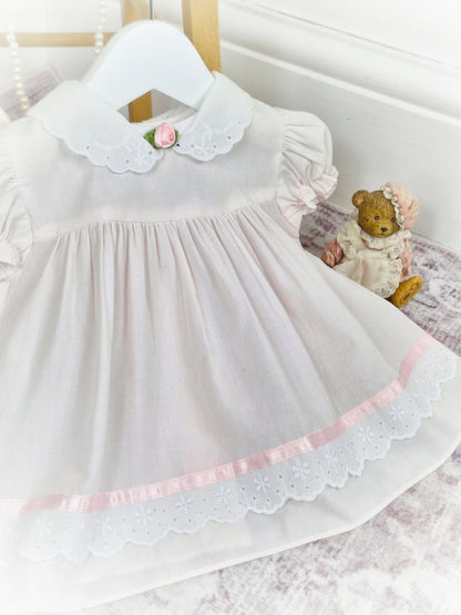 6-9 months. Light pink and white vintage dress from Bright Future with pink rosette and satin ribbon