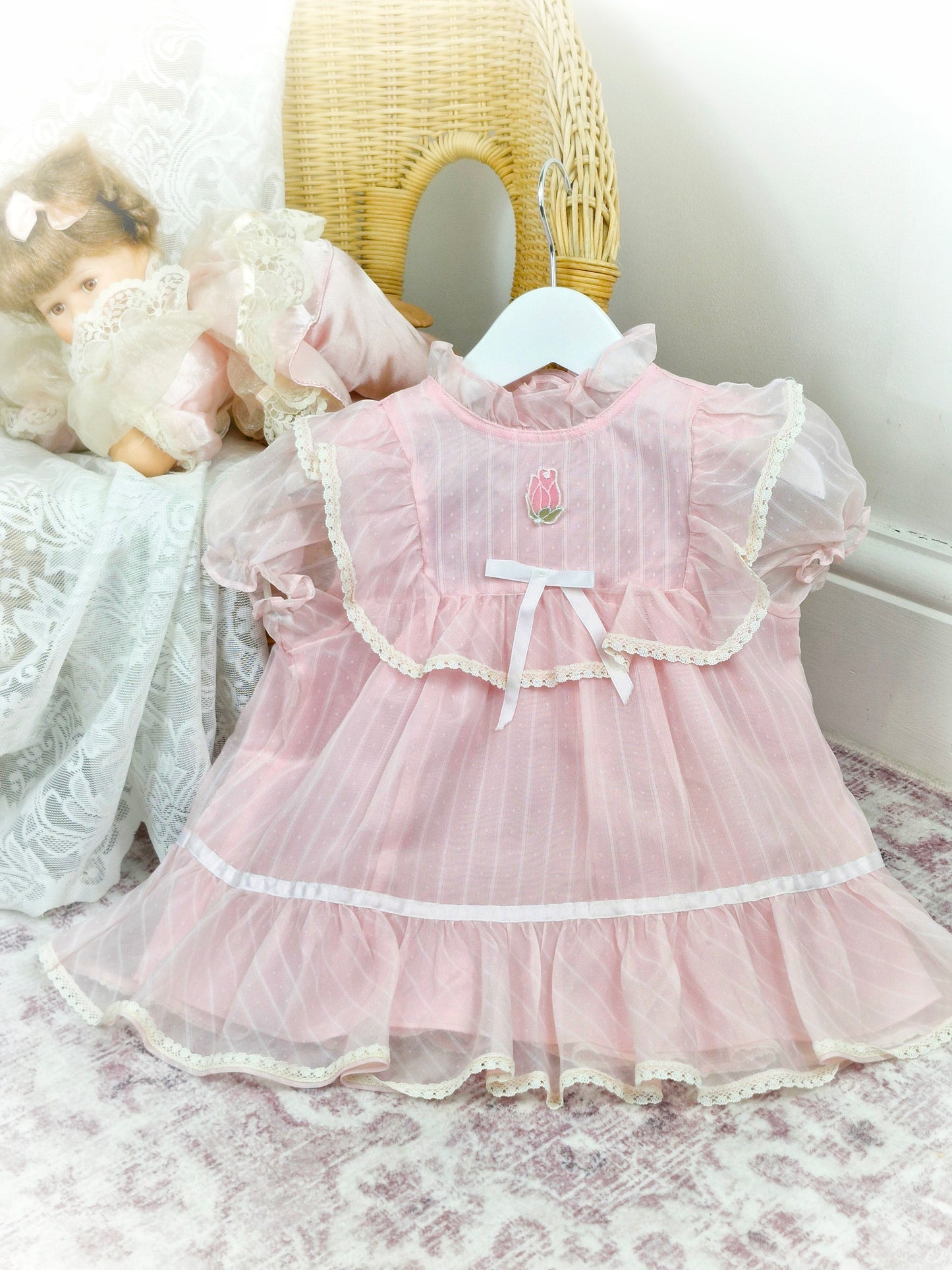 12-18 months. Light pink sheer vintage dress with lace, ruffles and white satin bow