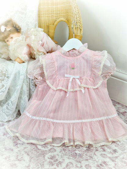 12-18 months. Light pink sheer vintage dress with lace, ruffles and white satin bow