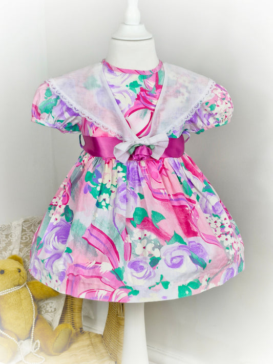 2-3 years. Vintage Roanna dress with vibrant pink print and white lace trimmed collar