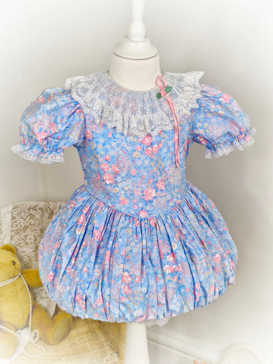 2-3 years. Blue bubble hem with pink and white flower print and white lace bib and trim by Jennifer Moore
