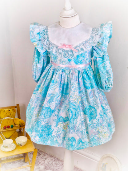 4-5 years. Cottagecore vintage dress with blues, pink and white details, long sleeves and flutter shoulders