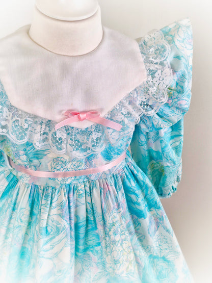4-5 years. Cottagecore vintage dress with blues, pink and white details, long sleeves and flutter shoulders