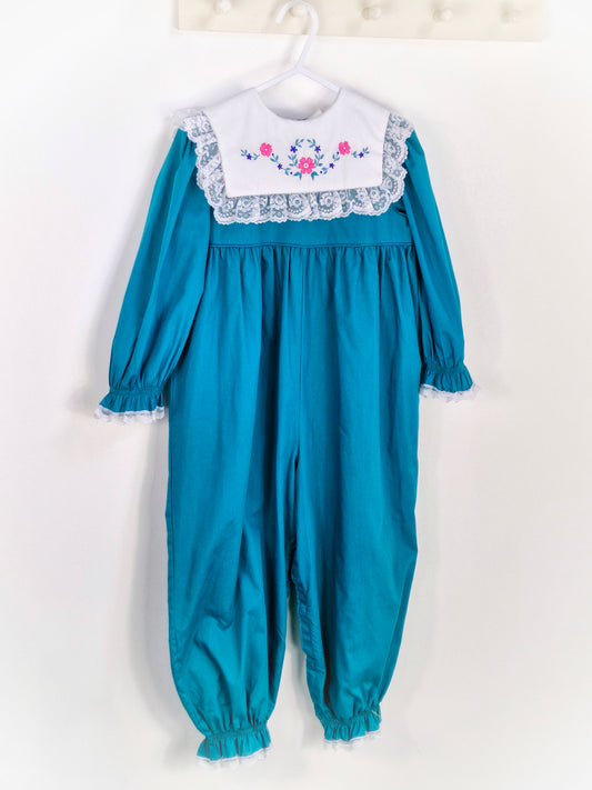 3 years. Teal vintage romper from Bryan with white bib, embroidered with flowers and trimmed with lace, cuffed wrists and ankles