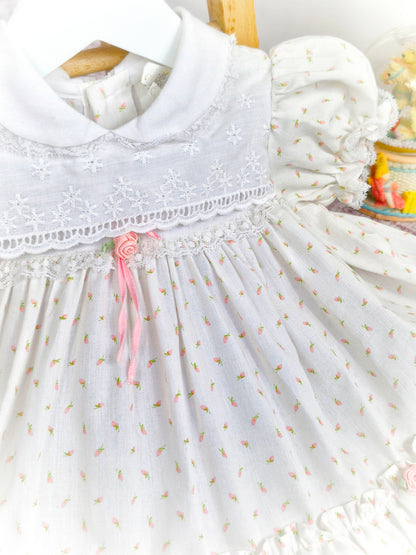 12-18 months. White vintage dress with pink floral print, rosettes and ribbon, puff sleeves and embroidered chest