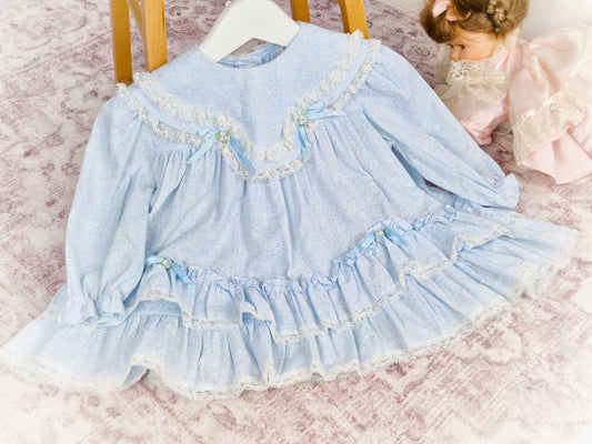 12 months. Light blue Hi-Girls vintage dress with white floral patterns, ruffles, lace and satin bows