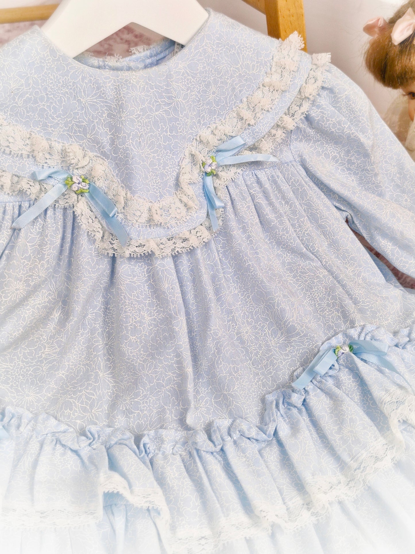 12 months. Light blue Hi-Girls vintage dress with white floral patterns, ruffles, lace and satin bows