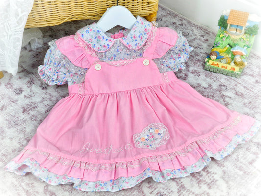 12 months. Pink vintage dress by Mayfair. Floral print, frills and embroidered "sweetheart"