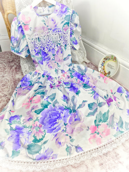 9-10 years. Vintage Jessica McClintock dress, white with purple floral designs, puff sleeves and lace bib details