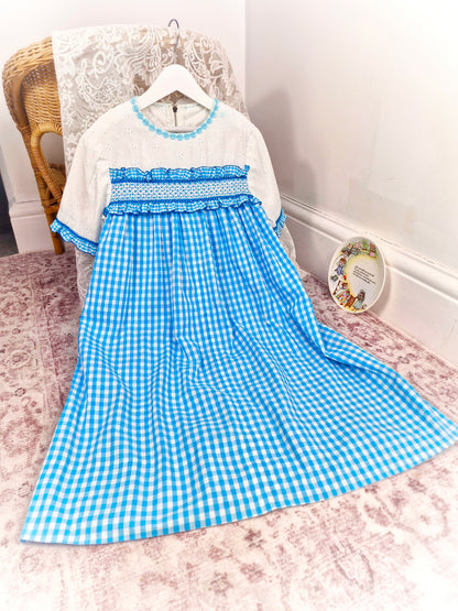 10 years. Blue and white gingham handmade dress with white eyelet cotton, ruffles and hand smocking