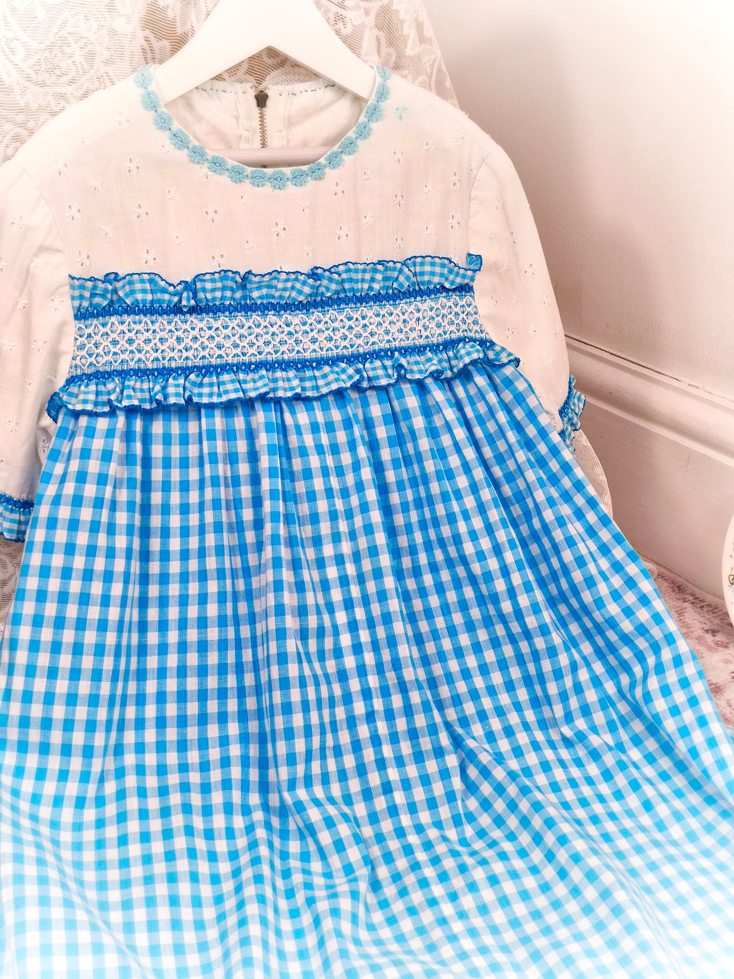 10 years. Blue and white gingham handmade dress with white eyelet cotton, ruffles and hand smocking
