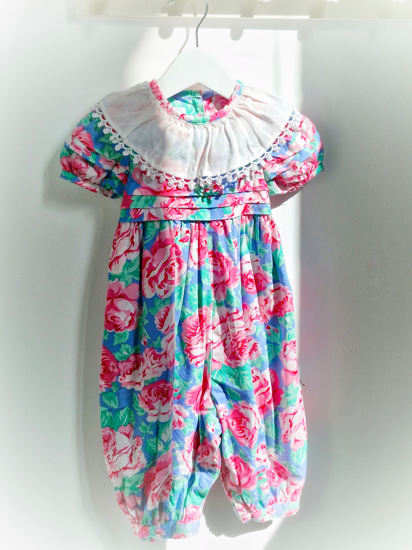 18 months. Pink and blue floral vintage romper with white bib by Baby Cary