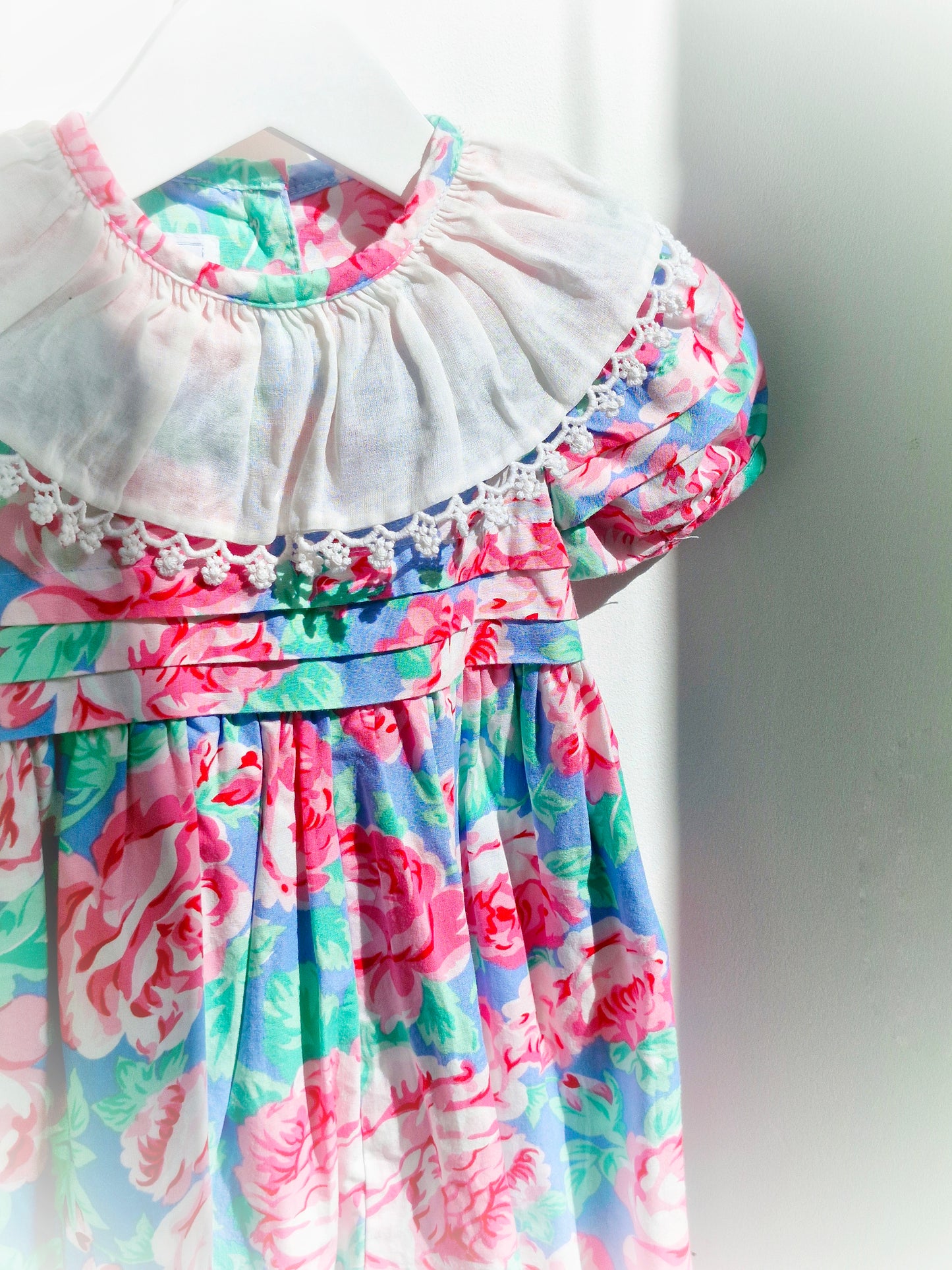 18 months. Pink and blue floral vintage romper with white bib by Baby Cary