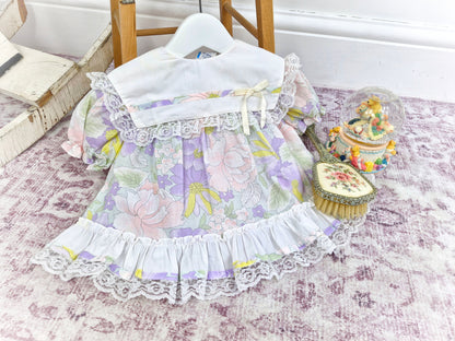 9-12 months. Pastel floral vintage dress with white bib and lace ruffles