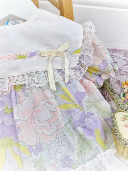 9-12 months. Pastel floral vintage dress with white bib and lace ruffles