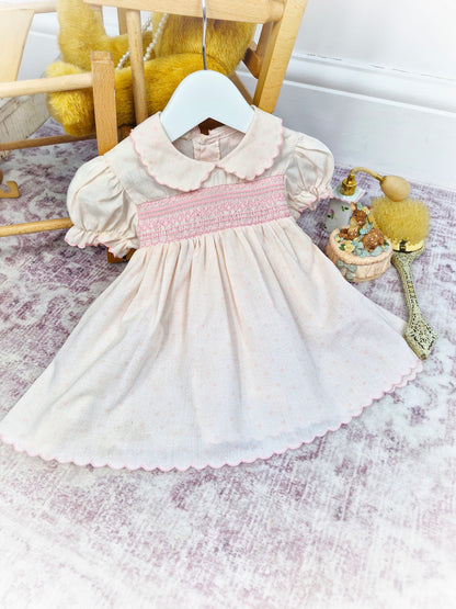9-12 months. Pink vintage smocked dress with darker pink embroidery, scalloped collar and hem & puff sleeves