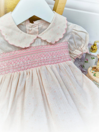 9-12 months. Pink vintage smocked dress with darker pink embroidery, scalloped collar and hem & puff sleeves