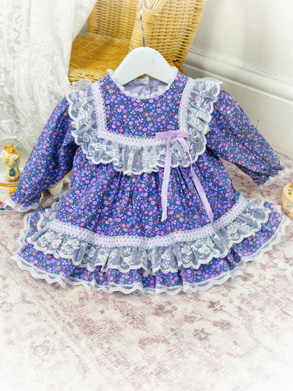 12 months. Purple floral vintage dress by Bryan with white lace details and lilac satin ribbon