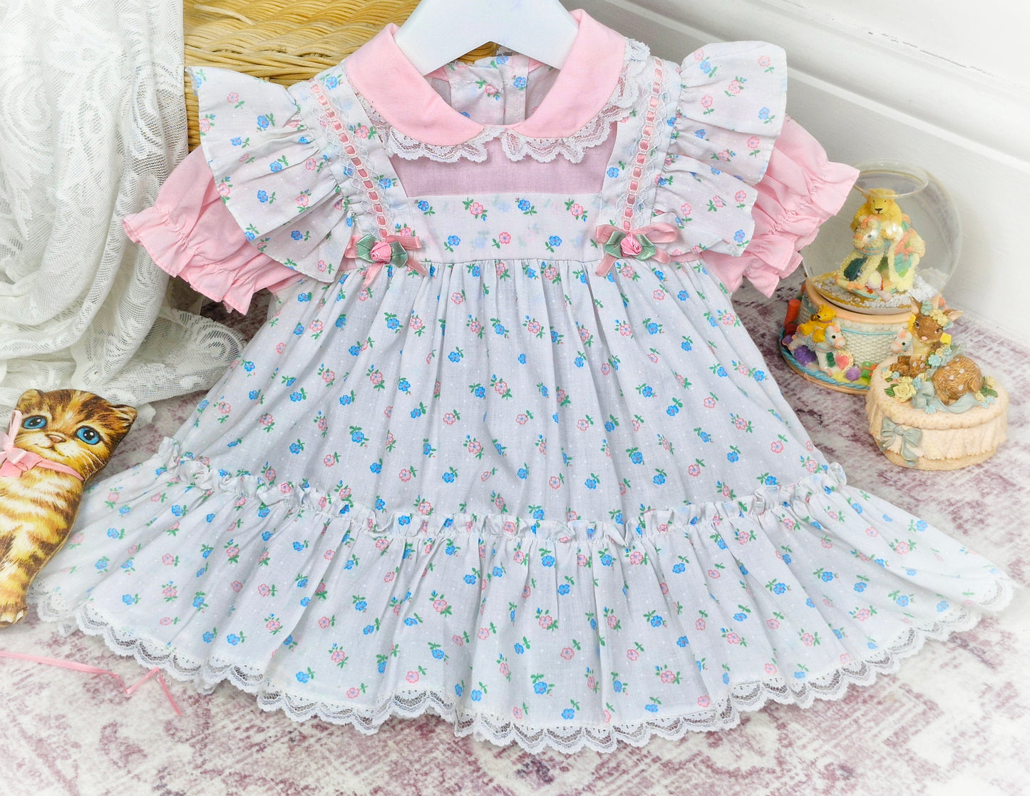 12 months. Pink and white vintage floral dress with ruffles, frills, ribbon and rosettes