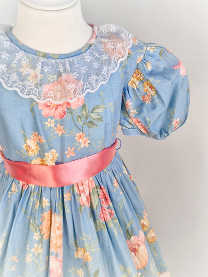 9-10 years. Blue vintage floral dress with pink roses, lace collar, puff sleeves and pink satin waist tie