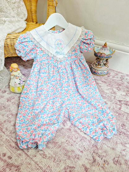 9-12 months. Pink and blue vintage floral romper with white bib and embroidered floral design