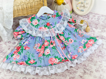 12-18 months. Gingham vintage dress with floral print and lace trim on bib and hem