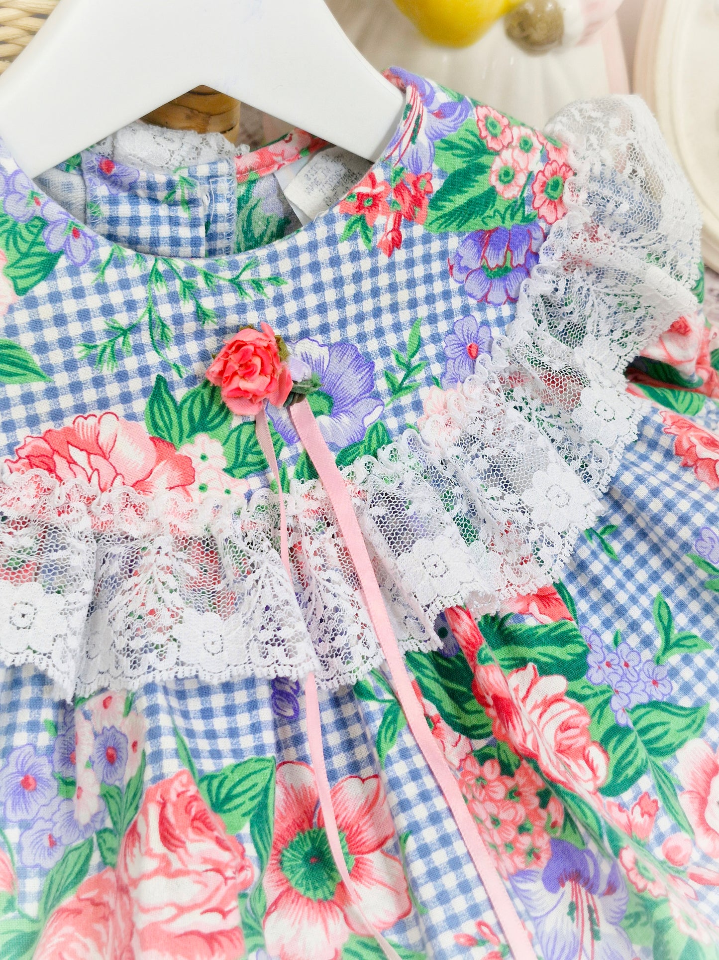 12-18 months. Gingham vintage dress with floral print and lace trim on bib and hem