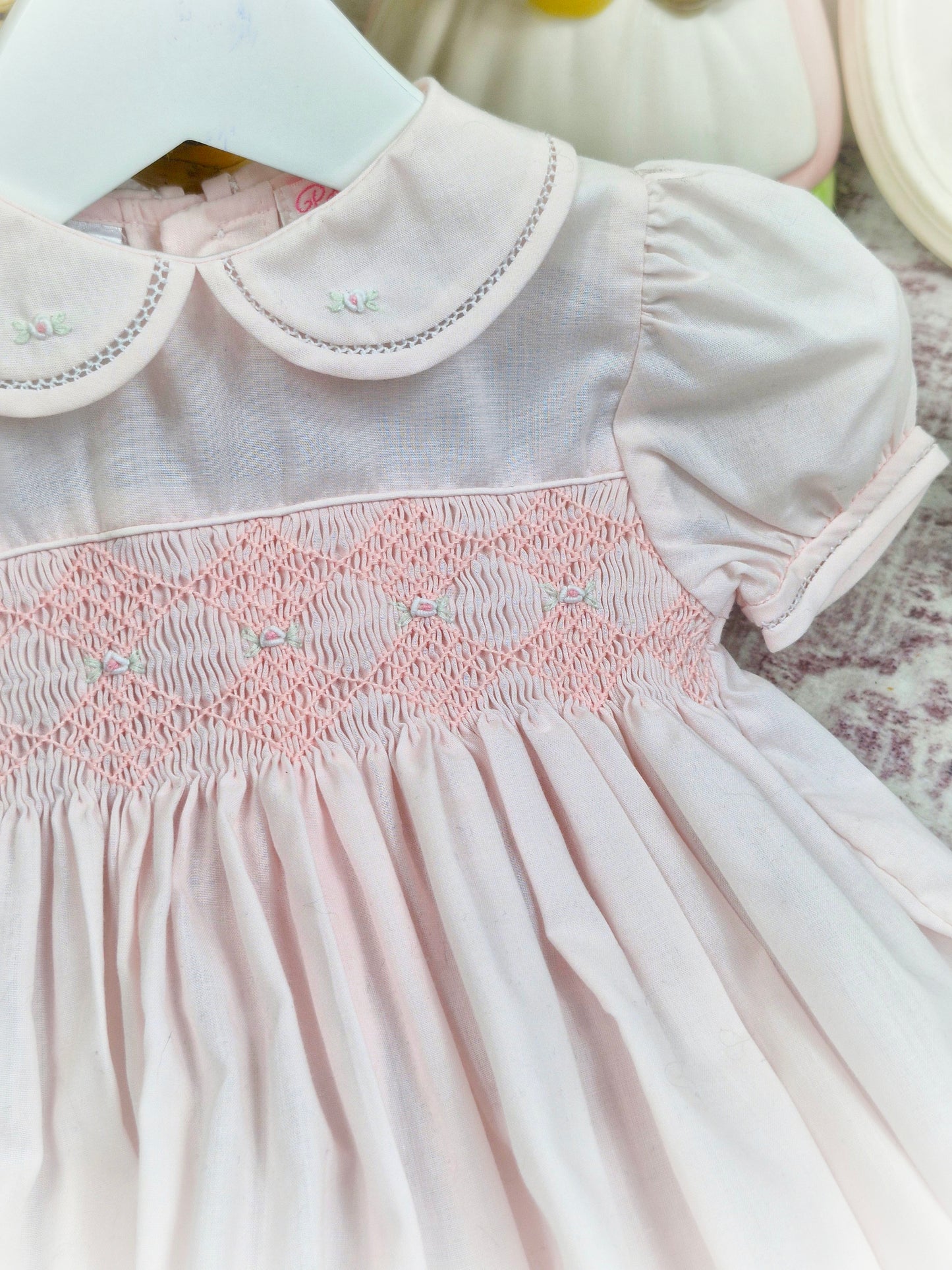12 months. Light pink Petit Ami smocked romper with puff sleeves