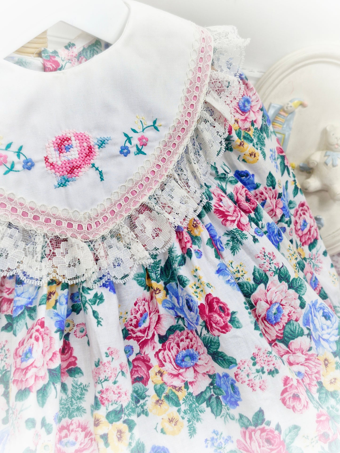 12-18 months. White vintage floral dress with large bib, embroidered with flowers and trimmed with lace