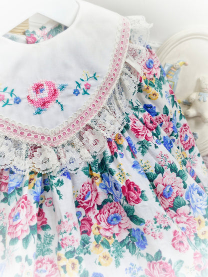 12-18 months. White vintage floral dress with large bib, embroidered with flowers and trimmed with lace