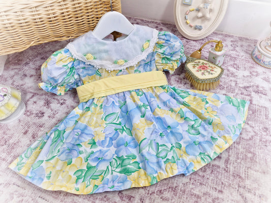 12-18 months. Lemon and blue vintage floral dress with white bib and rosettes
