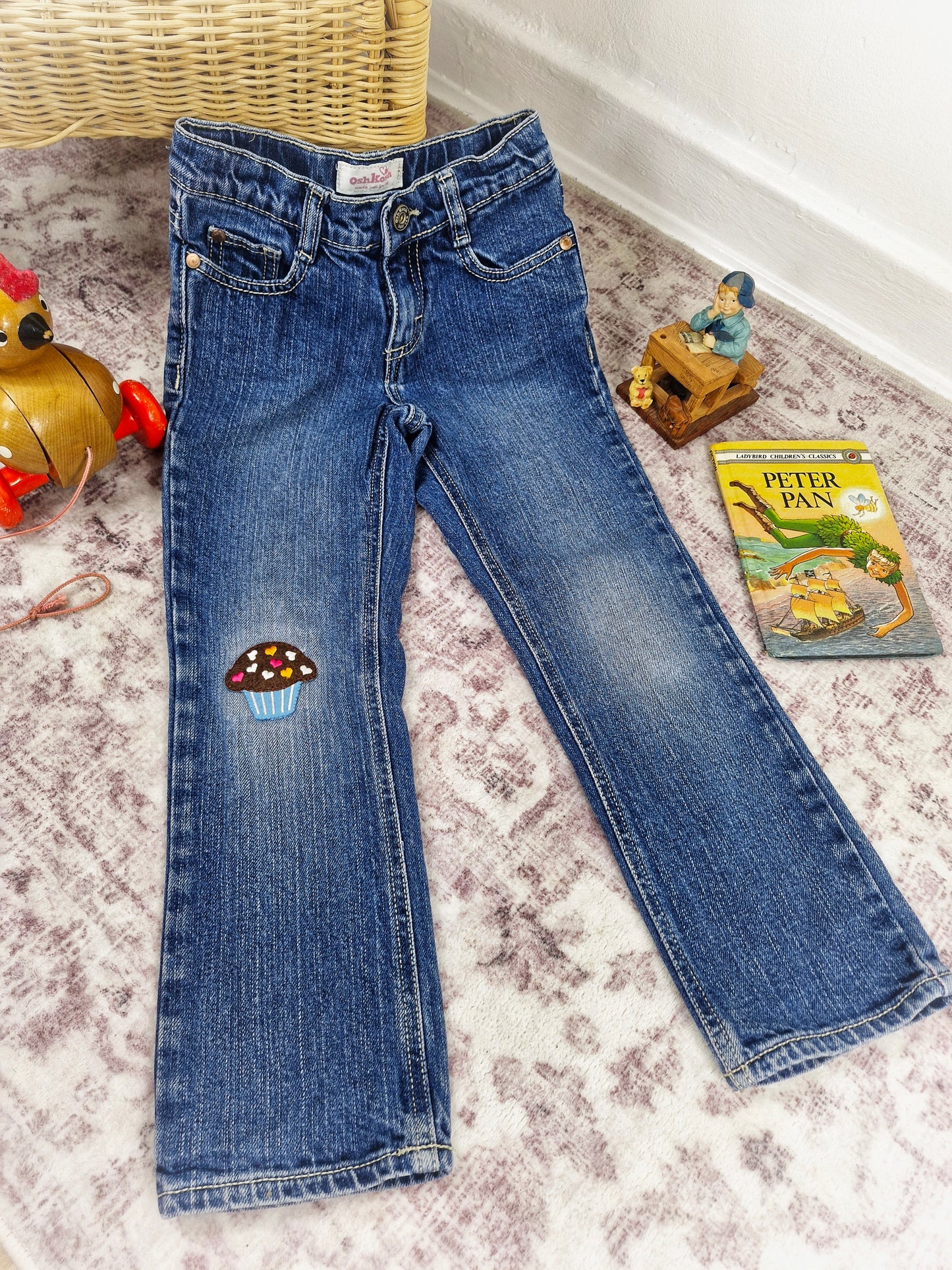 5 years. Oshkosh jeans with cupcake applique on the knee