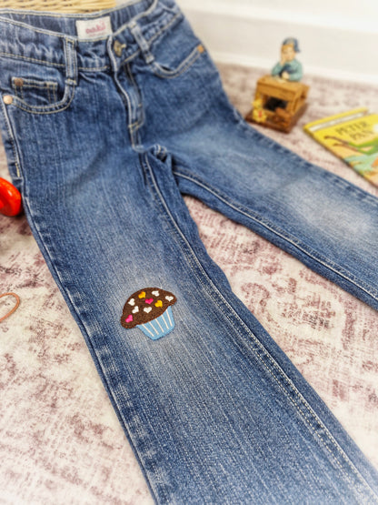 5 years. Oshkosh jeans with cupcake applique on the knee