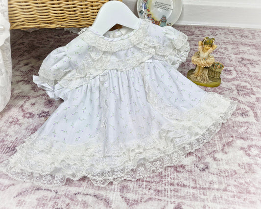 0-6 months. White vintage dress with lace trim and delicate floral print