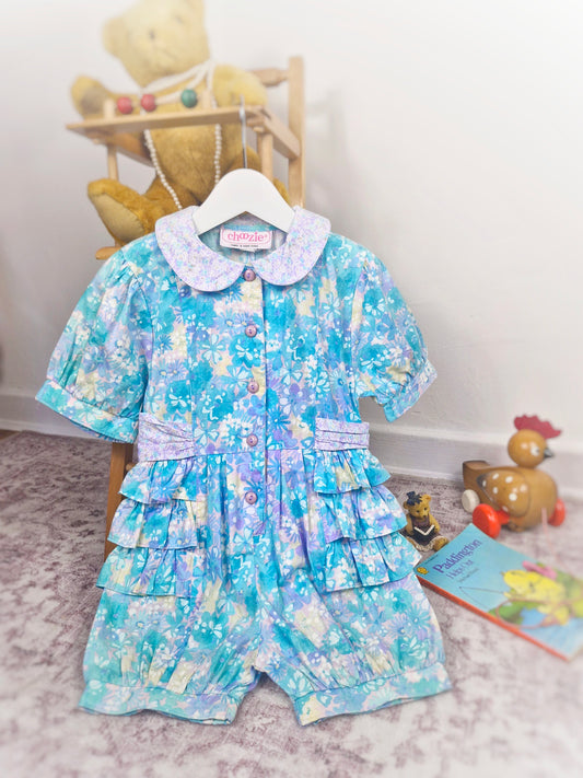 3 years. Floral button down romper with ruffle sides