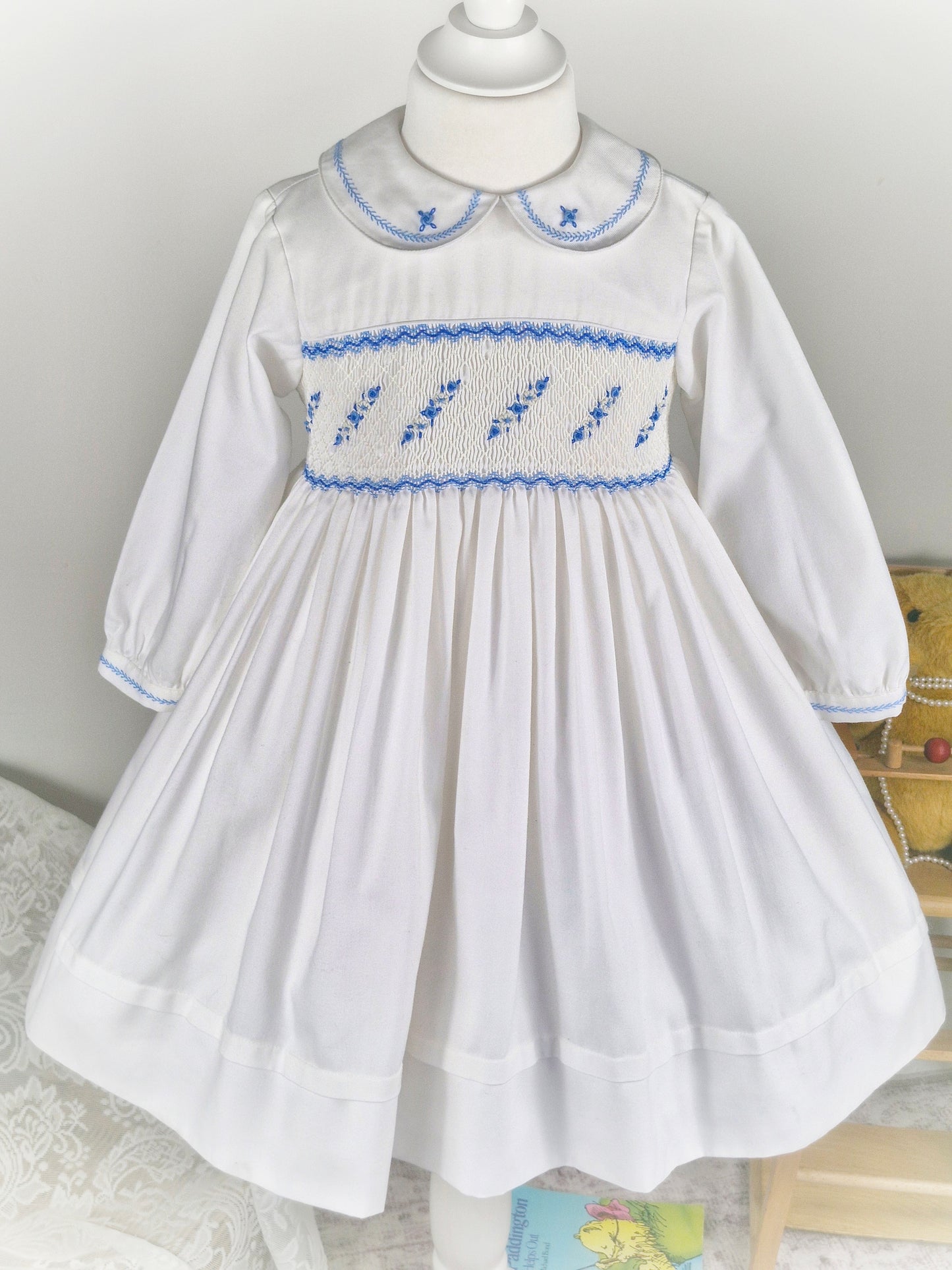 5 years. White Sarah Louise smock dress with blue embroidered flowers across chest and collar