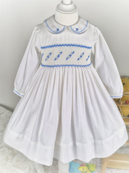 5 years. White Sarah Louise smock dress with blue embroidered flowers across chest and collar