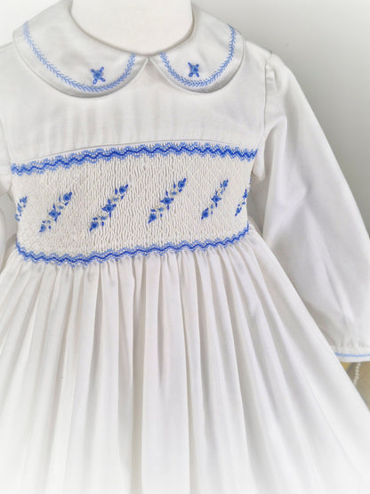 5 years. White Sarah Louise smock dress with blue embroidered flowers across chest and collar