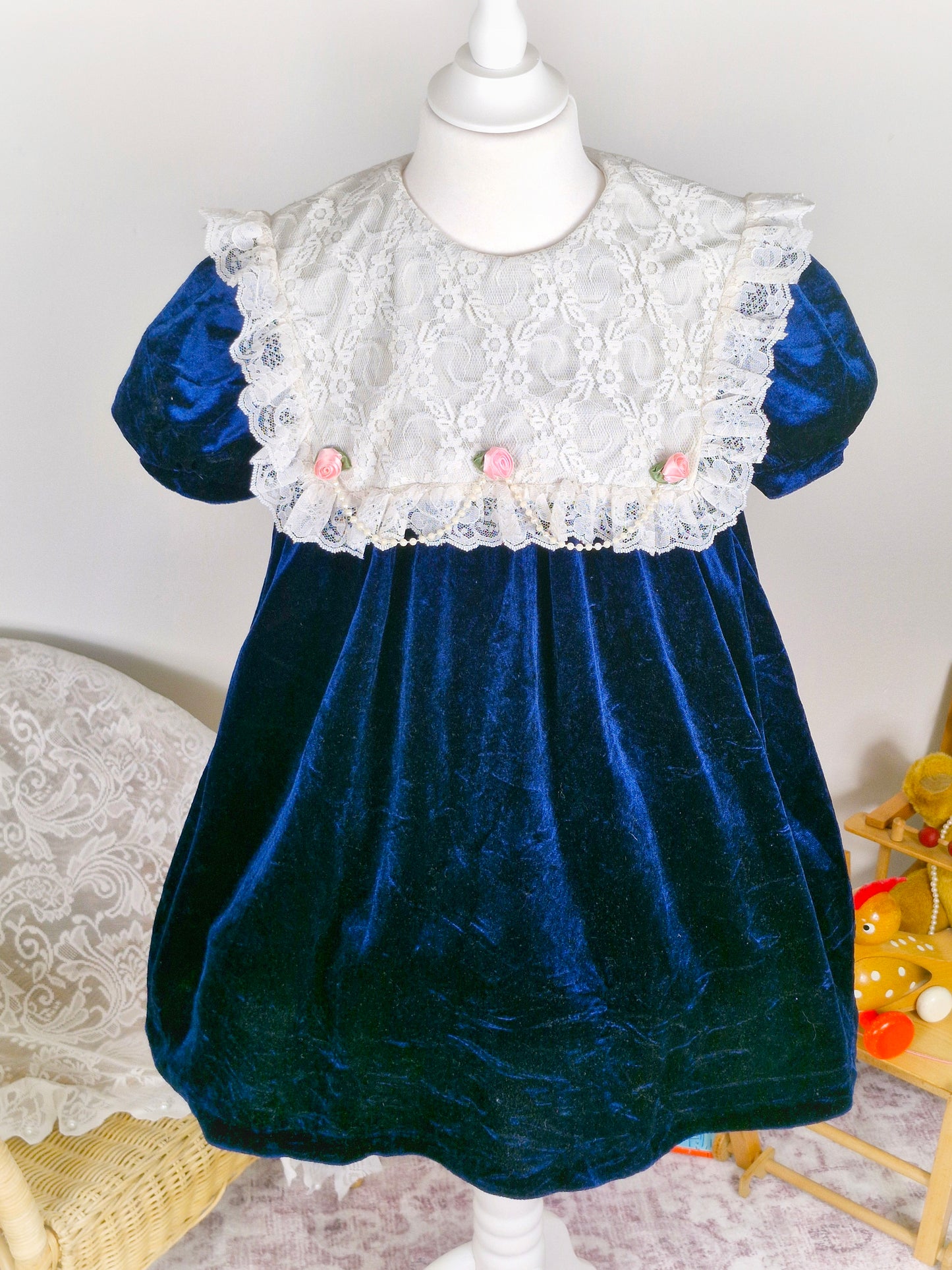 5-6 years. Navy velour vintage dress from Nutcracker with white lace bib, pink rosettes and pearl details