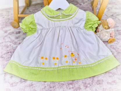 6-9 months. Green and white vintage gingham dress with embroidered ducks on a train